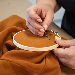 Begin to embroider your pattern to personalize thrifted clothes