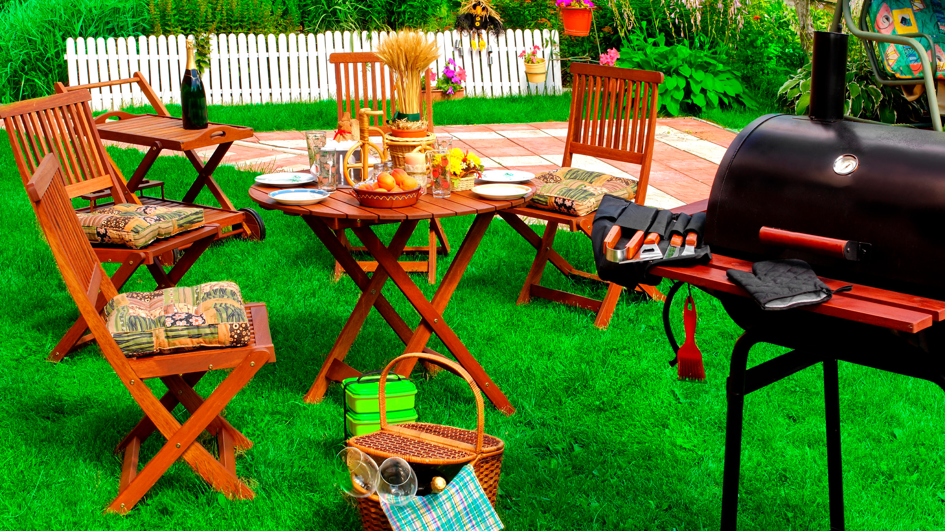 Image of a backyard with thrifted cookout treasures from Goodwill NCW