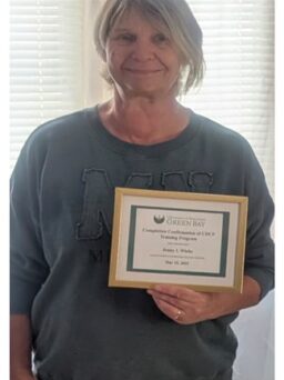 Jenny at 65 with her new path and certificate
