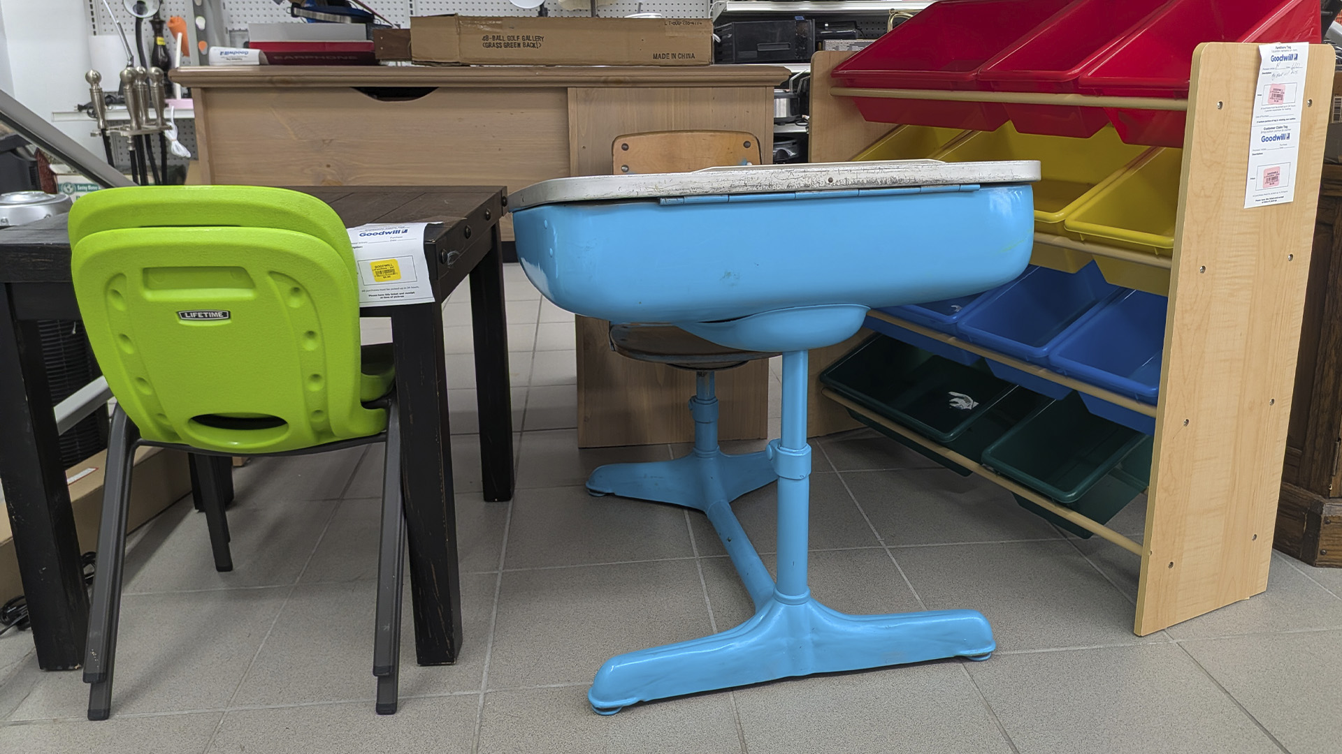 Image of a desk, table and chairs and storage for back-to-school shopping at Goodwill NCW